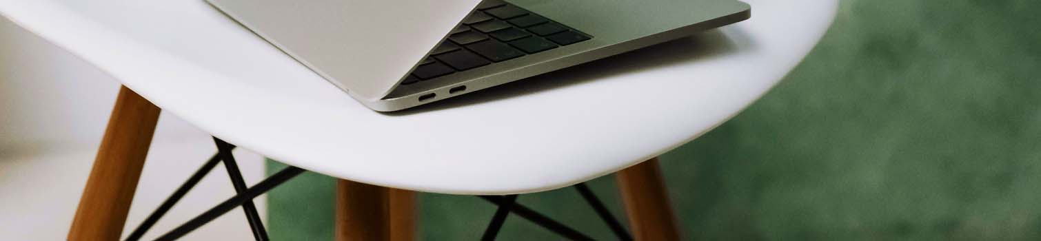 Laptop on a white table in a modern workspace